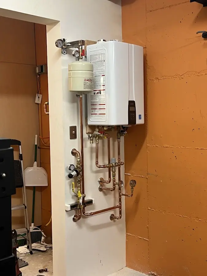Plumbing technician inspecting water heater connections in Silver Springs